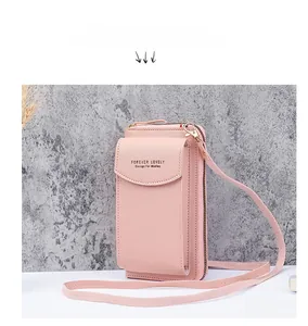 Detail of light pink lychee texture phone bag with magnetic flap and metal zipper