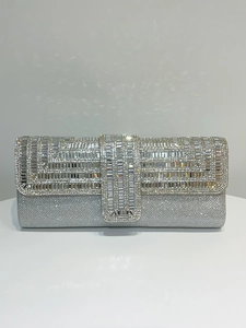 Detailed view of silver rectangular evening clutch with sparkling geometric rhinestone patterns