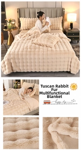 Detail of warm beige faux rabbit fur blanket with square quilted pattern and plush texture