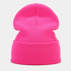 Close-up of neon pink ribbed knit beanie showing high-quality warm texture details