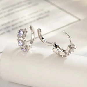 Silver hoop earrings with purple and white cubic zirconia stones in elegant still life