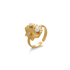 Elegant gold shell-shaped open ring with pearls and clear gemstone on white background