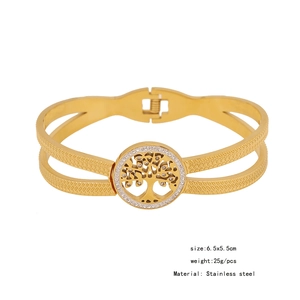 Macro shot of gold stainless steel tree of life bangle with hollow design and crystals