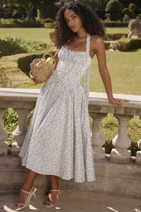 Close-up of floral halter maxi dress featuring a backless drawstring and blue flower print