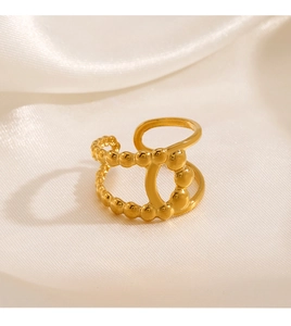 Detailed view of 18K gold plated beaded double layer ring on soft white silk fabric