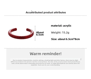 Detail showing red acrylic cuff bracelet with black marble pattern and 6.5cm inner diameter