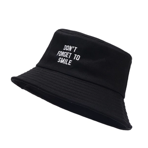 Black cotton bucket hat with white embroidery 'Don't Forget To Smile' on front