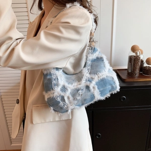Blue denim crossbody bag with white plush grid and acrylic chain on model