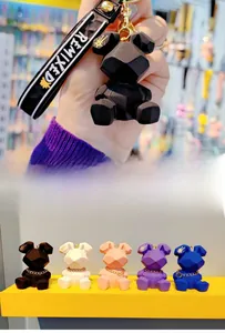 Macro shot of geometric resin rabbit keychains in black, pink, blue, purple, and white colors