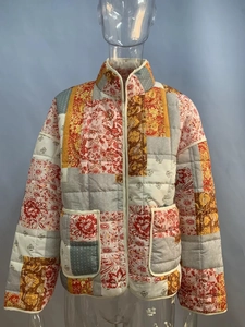 Detail of a women's quilted patchwork jacket featuring vintage floral and stripe patterns