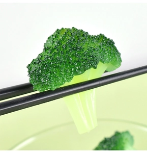 Macro detail of realistic artificial broccoli keychain showing vivid green texture