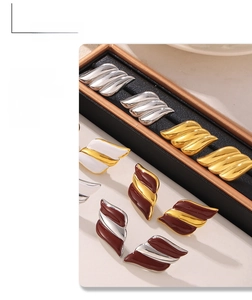 Detailed view of wave-shaped 18k gold-plated titanium earrings in various colors
