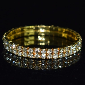 Macro detail of gold-plated double-row crystal bracelet with sparkling rhinestones