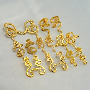 Collection of golden snake-shaped stainless steel earrings in various artistic designs
