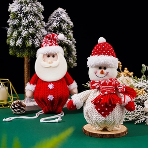 Detail of knitted Santa and Snowman Christmas treat bags with festive drawstring texture