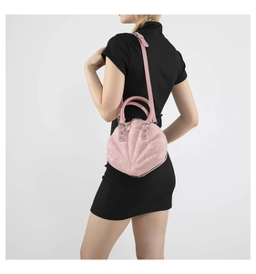Detail of pink shell-shaped bag featuring floral lace embroidery and silver hardware