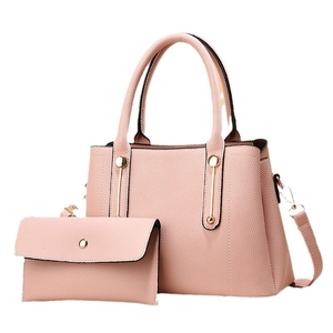 Pink lychee grain leather handbag set with tote and clutch featuring gold hardware