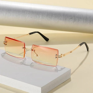 Retro rimless square sunglasses with orange gradient lenses and gold metal frames
