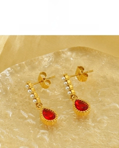 Macro view of teardrop red gemstone earrings with 18K vacuum plating and white pearls