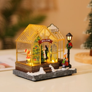Illuminated Christmas greenhouse miniature with LED lights, snow scene, and festive trees