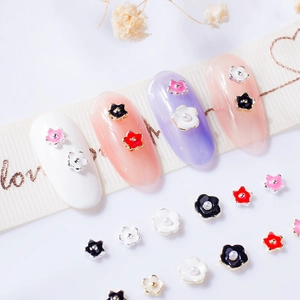 3D mini five-petal flower nail charms in pink, black, red, and white with pearl center