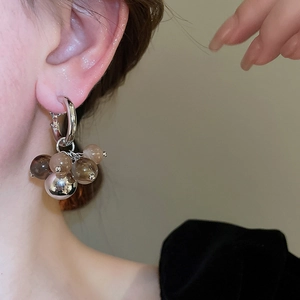Close-up of Maillard style earrings with gradient brown resin beads on silver hoops
