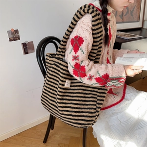 Black and brown striped plush tote bag with 'make a heart' label shown on shoulder