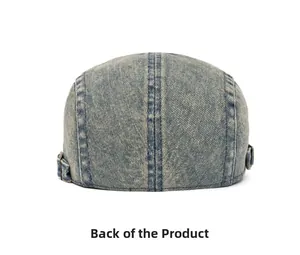 Detail of adjustable metal buckles on the back of a vintage washed denim beret cap