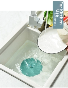 Close-up of green silicone sink stopper for water storage in a modern kitchen sink