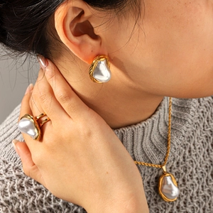 Baroque pearl jewelry set with twisted chain, ring, and earrings on model