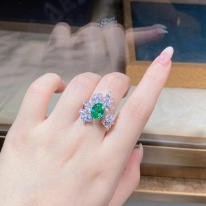 Close-up of S925 silver ring featuring a large green emerald zircon in a floral setting