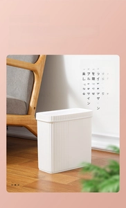 Close-up of narrow white trash can with vertical textures in a modern minimalist home decor