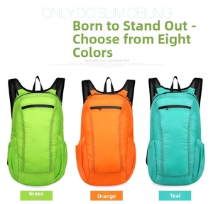 Close-up of lightweight nylon foldable backpacks in green, orange, and blue with mesh pockets