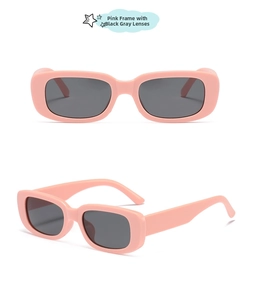Close-up of square kids sunglasses with pink jelly frame and dark grey lenses