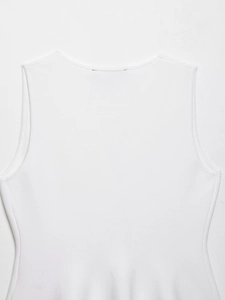 Macro shot of white sleeveless knit top texture and clean stitch detail for women
