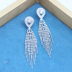 Close-up of long silver fringe earrings with white rhinestones in a blue velvet box