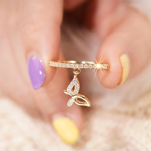 Macro shot of 18K gold plated butterfly pendant ring with shimmering zircon micro-inlays