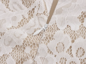 Detail of the high-quality white lace fabric and invisible zipper on the elegant skirt