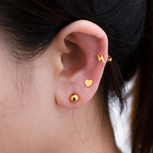 Set of 18k gold plated stainless steel studs featuring ball, heart, and lightning designs