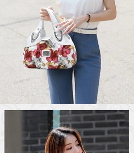 Detail of floral printed white handbag with silver rings held by model in outdoor setting