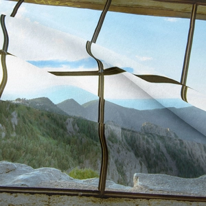 Detailed texture of bohemian tapestry showing blue sky and mountain landscape print