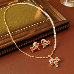 Detailed view of horse pendant jewelry set with gold chains and white pearls
