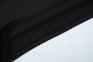 Detailed macro view showing the high-density double-needle stitching on the black top hem