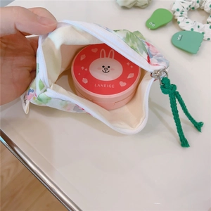 Macro view of floral cotton storage bag interior showing space for makeup cushions