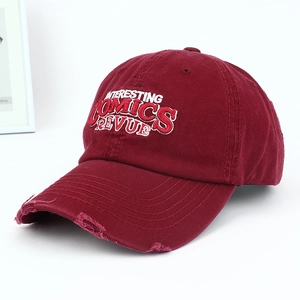 Macro shot of the distressed brim and vintage 3D embroidery on this burgundy baseball cap