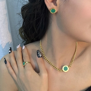 Golden stainless steel jewelry set featuring round green malachite style pendants and cubes