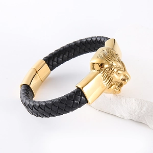 Men's braided black leather bracelet with golden lion head charm on white stone