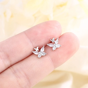 Minimalist S925 silver butterfly stud earrings with sparkling cubic zirconia on a finger