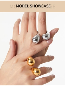 Close-up of gold and silver teardrop rings featuring a high-polish mirror finish