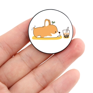Close-up of a round phone grip featuring a cartoon Corgi drinking pearl milk tea design